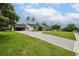 Attractive home featuring a driveway, lush green lawn, and well-maintained landscaping at 1425 Hallam Dr, Lakeland, FL 33813