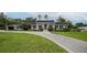 Charming single story home featuring a beautifully landscaped lawn and a circular driveway at 1425 Hallam Dr, Lakeland, FL 33813
