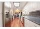 Well-lit kitchen featuring white cabinets, stainless steel appliances, and terra cotta tile flooring at 1425 Hallam Dr, Lakeland, FL 33813