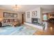 Cozy living room with brick fireplace, unique coffee table and hardwood flooring at 1425 Hallam Dr, Lakeland, FL 33813