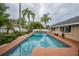 A private backyard pool surrounded by lush greenery, offering a serene escape at 1425 Hallam Dr, Lakeland, FL 33813