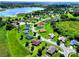 This elevated view showcases a well-maintained neighborhood with lush greenery, mature trees, and proximity to a serene lake at 1531 Blue Sky Blvd, Haines City, FL 33844