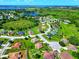 This aerial perspective captures the property's placement within a lush, green neighborhood, complete with lakes in the distance at 1531 Blue Sky Blvd, Haines City, FL 33844