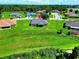 The property is set on a large grassy lot, featuring a well-kept house with mature trees and landscaping at 1531 Blue Sky Blvd, Haines City, FL 33844