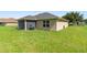 Exterior view of the rear of the property showcasing the screened lanai and grill at 1531 Blue Sky Blvd, Haines City, FL 33844