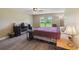 Comfortable bedroom featuring a ceiling fan, window, and wood-look flooring for a modern feel at 1531 Blue Sky Blvd, Haines City, FL 33844