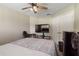 This bedroom features a ceiling fan, closet, and a television with a gaming console and mini fridge nearby at 1531 Blue Sky Blvd, Haines City, FL 33844