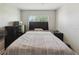 Bedroom featuring light gray walls, a window, and neutral patterned bedding at 1531 Blue Sky Blvd, Haines City, FL 33844