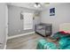 Bedroom featuring gray walls, a crib and a bed with dinosaur sheets at 1531 Blue Sky Blvd, Haines City, FL 33844