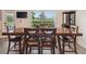 Formal dining room with a wooden table set, chairs and a view of the yard at 1531 Blue Sky Blvd, Haines City, FL 33844