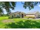 Charming single-story home featuring a well-manicured lawn and lush landscaping, offering great curb appeal at 1531 Blue Sky Blvd, Haines City, FL 33844