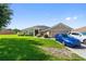 Charming single-story home with well-manicured lawn, attached garage, and neutral paint scheme at 1531 Blue Sky Blvd, Haines City, FL 33844