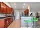 Well-equipped kitchen featuring stainless steel appliances, rich wood cabinets, and modern finishes at 1531 Blue Sky Blvd, Haines City, FL 33844