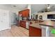 Open kitchen showcasing a breakfast bar, stainless steel refrigerator, and ample counter space at 1531 Blue Sky Blvd, Haines City, FL 33844