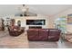 Large living room with hardwood floors, leather furniture and cathedral ceilings at 1531 Blue Sky Blvd, Haines City, FL 33844