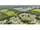 Wide aerial shot of a community featuring houses surrounded by lush greenery and trees at 1746 Grey Fox Dr, Lakeland, FL 33810
