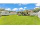 Spacious backyard with shed and view of home's back elevation at 1746 Grey Fox Dr, Lakeland, FL 33810