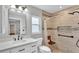 Updated bathroom featuring white vanity with black hardware and tiled walk-in shower with built-in bench and niche at 1746 Grey Fox Dr, Lakeland, FL 33810