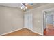 This bedroom features wood-look floors, a ceiling fan, double closet, and neutral walls at 1746 Grey Fox Dr, Lakeland, FL 33810