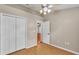 This bedroom features wood-look floors, a ceiling fan, double closet, and neutral walls at 1746 Grey Fox Dr, Lakeland, FL 33810