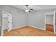 This is a light and airy bedroom featuring wood-look floors, ceiling fan, walk-in closet, and neutral paint at 1746 Grey Fox Dr, Lakeland, FL 33810