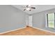 Bright bedroom with vaulted ceiling, wood-look floors, a neutral palette, and a window that lets in natural light at 1746 Grey Fox Dr, Lakeland, FL 33810