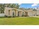 Attractive single-level home with a lush green lawn and a welcoming, blue-accented entrance at 1746 Grey Fox Dr, Lakeland, FL 33810