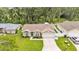 Charming home exterior with a well-kept lawn, fenced backyard, and wide driveway at 1746 Grey Fox Dr, Lakeland, FL 33810
