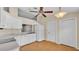Well-lit kitchen with white cabinets, appliances, and wood-look flooring at 1746 Grey Fox Dr, Lakeland, FL 33810