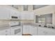 Neat kitchen with white appliances, plenty of cabinet space and a view to the backyard at 1746 Grey Fox Dr, Lakeland, FL 33810