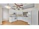 Bright kitchen featuring white appliances, cabinetry, and light wood-look flooring at 1746 Grey Fox Dr, Lakeland, FL 33810