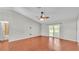 Open living area with wood floors, ceiling fan and sliding door access to the backyard at 1746 Grey Fox Dr, Lakeland, FL 33810