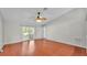 Expansive living area with hardwood floors, ceiling fan and backyard access at 1746 Grey Fox Dr, Lakeland, FL 33810
