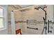 Nicely tiled walk-in shower featuring a shower bench, adjustable shower head, niche and safety bar at 1746 Grey Fox Dr, Lakeland, FL 33810