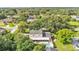 Aerial view of a home with fenced-in yard, pool, and lush trees at 1910 Clubhouse Rd, Lakeland, FL 33813
