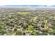 Expansive aerial view of a residential neighborhood with lush greenery and a community park, perfect for serene living at 1910 Clubhouse Rd, Lakeland, FL 33813