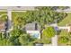 An aerial view of a suburban home featuring a pool, trampoline, and green surroundings at 1910 Clubhouse Rd, Lakeland, FL 33813