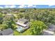 Aerial view of home with pool, screened porch, and lush landscaping at 1910 Clubhouse Rd, Lakeland, FL 33813