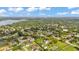 Beautiful aerial shot showcasing the property's lush surroundings, swimming pool, manicured lawns, and tennis court at 1910 Clubhouse Rd, Lakeland, FL 33813