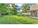 Spacious backyard with well-maintained lawn, a playset, trampoline, and white privacy fence at 1910 Clubhouse Rd, Lakeland, FL 33813