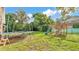 Lush backyard with a trampoline, playset, and plenty of space for Gathering fun and recreation at 1910 Clubhouse Rd, Lakeland, FL 33813