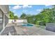 Refreshing in-ground pool in a private backyard setting, surrounded by lush greenery and a white fence at 1910 Clubhouse Rd, Lakeland, FL 33813