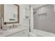 Modern bathroom featuring a combination shower and tub with stylish grey tile surround at 1910 Clubhouse Rd, Lakeland, FL 33813