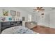 Inviting bedroom with a dinosaur theme, hardwood floors, and comfortable seating area at 1910 Clubhouse Rd, Lakeland, FL 33813