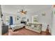 Bright bedroom with hardwood floors, ceiling fan, and neutral-toned sofa at 1910 Clubhouse Rd, Lakeland, FL 33813