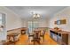 Well-lit dining room with hardwood floors, chandelier, and table with chairs at 1910 Clubhouse Rd, Lakeland, FL 33813