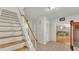 Foyer view showcases a staircase, closet, and an open living area with wood floors at 1910 Clubhouse Rd, Lakeland, FL 33813