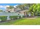 View of the side of the property with privacy fence, landscaping, and home details at 1910 Clubhouse Rd, Lakeland, FL 33813