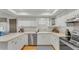 Modern kitchen boasting white cabinets, stainless steel appliances, and ample counter space at 1910 Clubhouse Rd, Lakeland, FL 33813