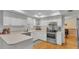 Bright kitchen features white cabinets, countertops, and stainless steel appliances at 1910 Clubhouse Rd, Lakeland, FL 33813